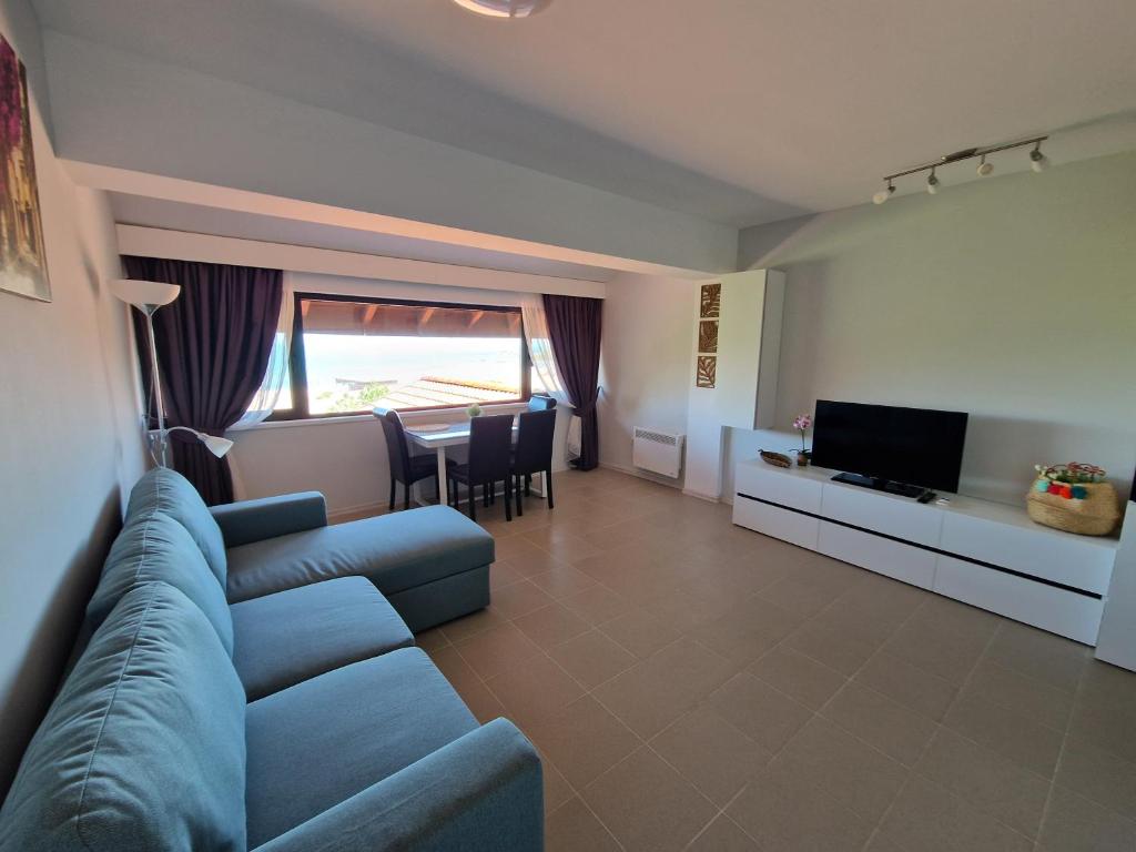 a living room with a blue couch and a television at INFINITY VIEW 8 Lozenets in Lozenets