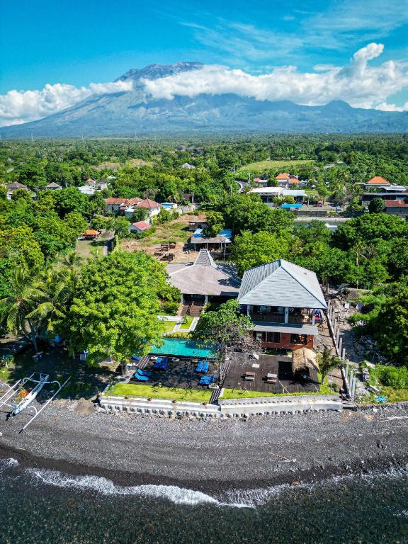 an aerial view of a resort with mountains in the background at Villa Kampung Kecil Beach Front in Kubu
