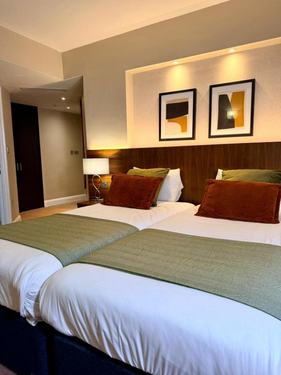 two beds sitting next to each other in a hotel room at Fenwick Street Hotel by EPIC, Central Rooms Near Waterfront & Liverpool ONE in Liverpool