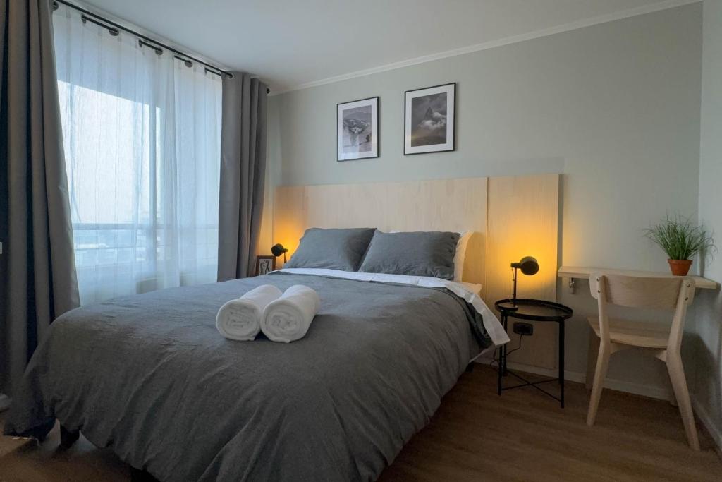 a bedroom with a bed with two towels on it at Manuel Montt Spot by AndesPlus in Santiago