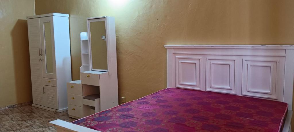 an empty room with a closet and a mirror at Michenzani rooms apartment in Ngambo