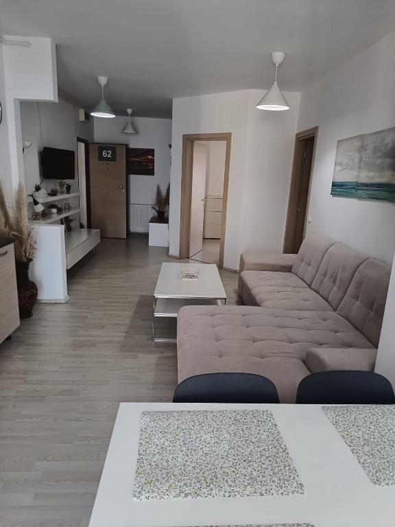 a living room with a couch and a table at Sea View 3-Room Apartment in Olimp