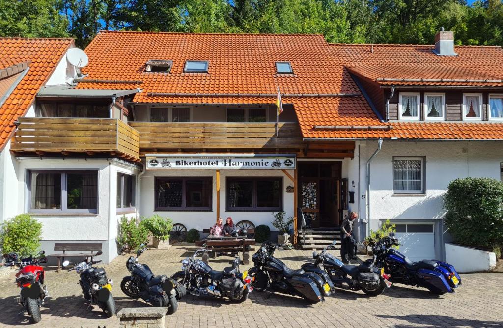 a group of motorcycles parked in front of a building at Biker Hotel Harmonie in Bad Grund