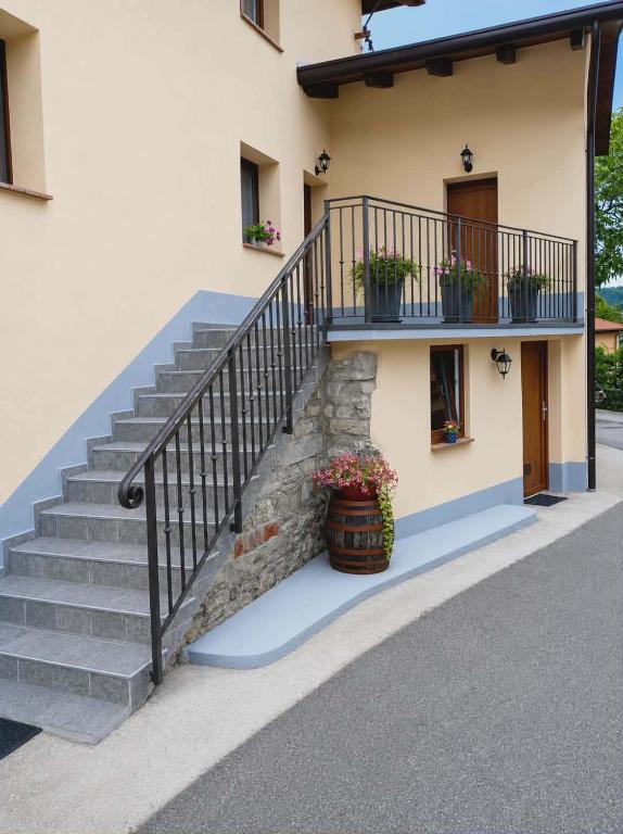 a stairway with potted plants on a building at Apartma PERIN in Dobrovo