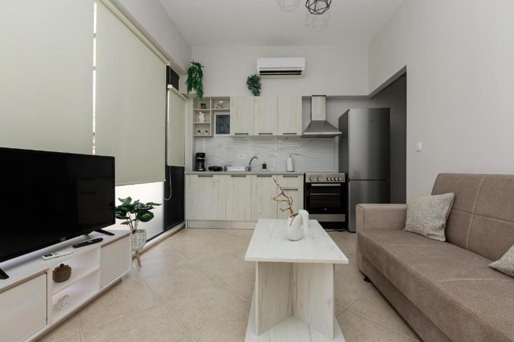 a living room with a couch and a table at Stella's Apartment in Karfas