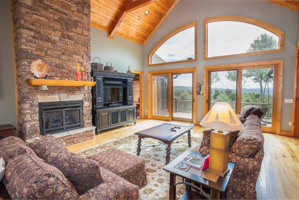 a living room with a couch and a fireplace at Ridgeline Cabin in Elk Park
