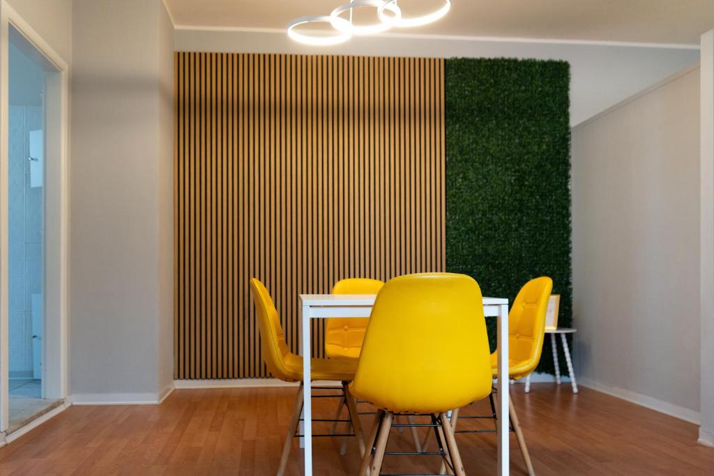a dining room with a table and yellow chairs at Central Viale in Telese