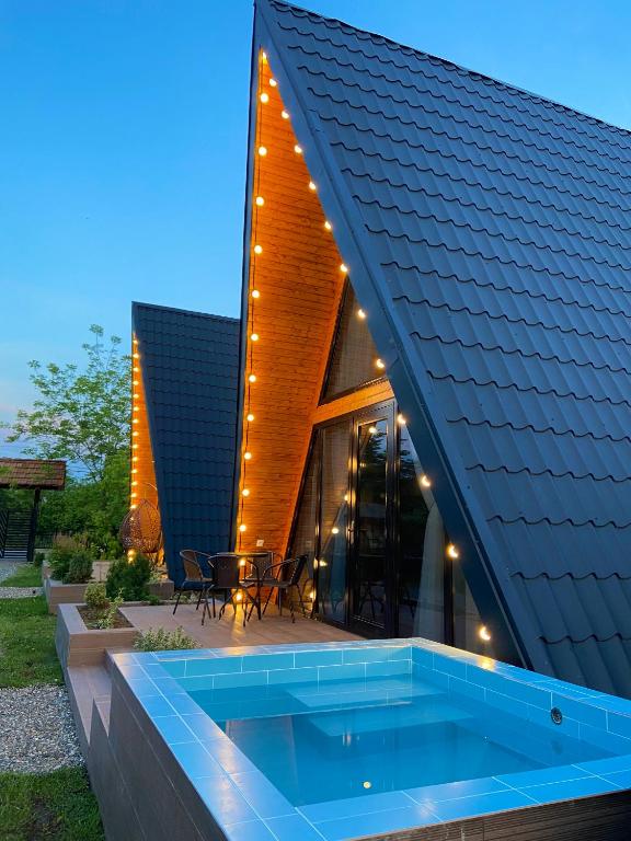an external view of a house with a swimming pool at Cozy Cottage Martvili in Martvili