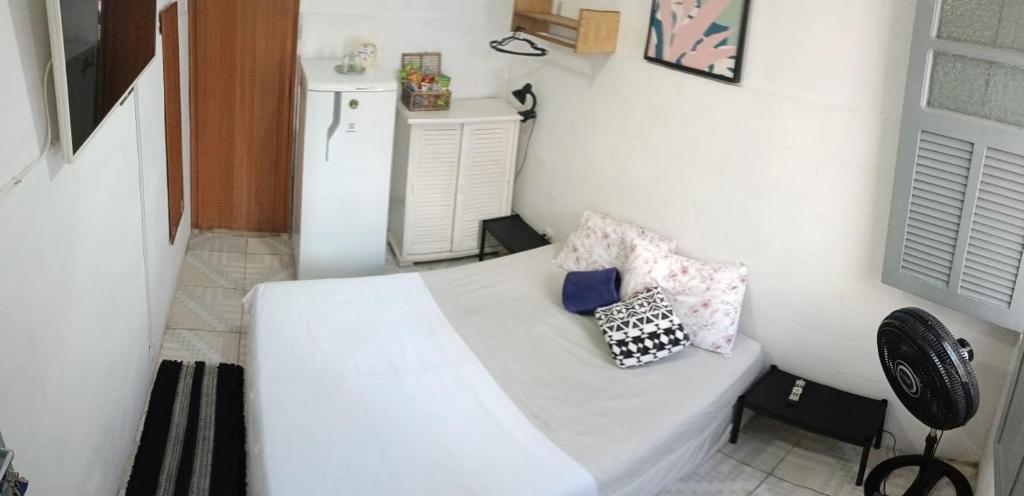 a bedroom with a white bed with two pillows on it at Rio Private Budget Suite & Easy Transport Access in Rio de Janeiro