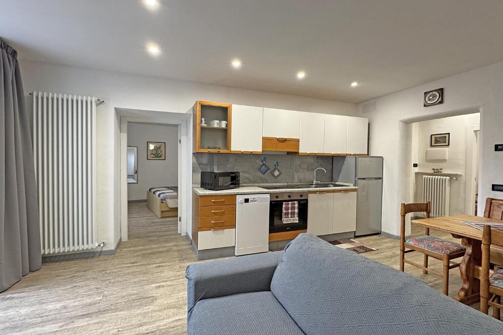 a kitchen and living room with a couch and a table at All'antica Birreria in Predazzo