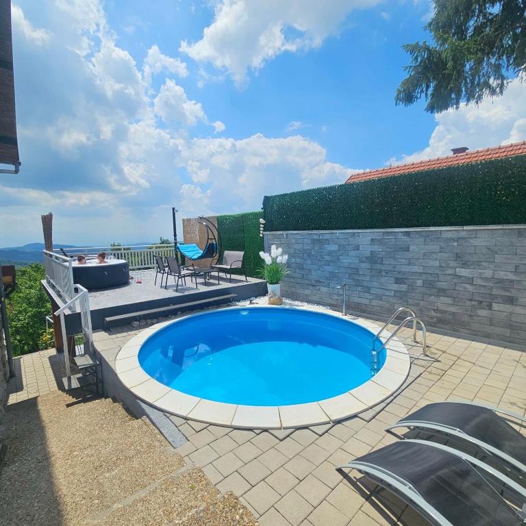 a swimming pool in a yard with a patio at Vikendica Dania in Tuzla