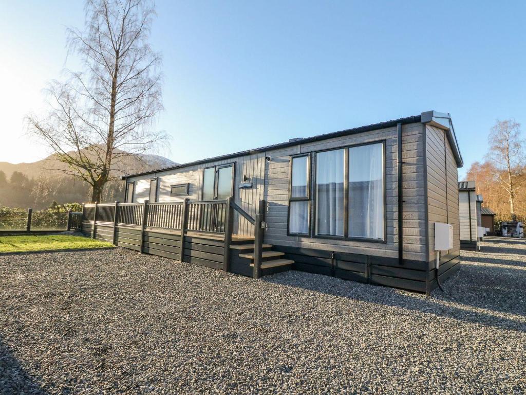 a tiny house sitting on top of a gravel lot at Hollybirch in Crieff