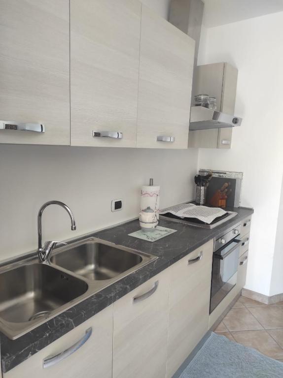a kitchen with white cabinets and a sink at CASA BETTO in San Domenico