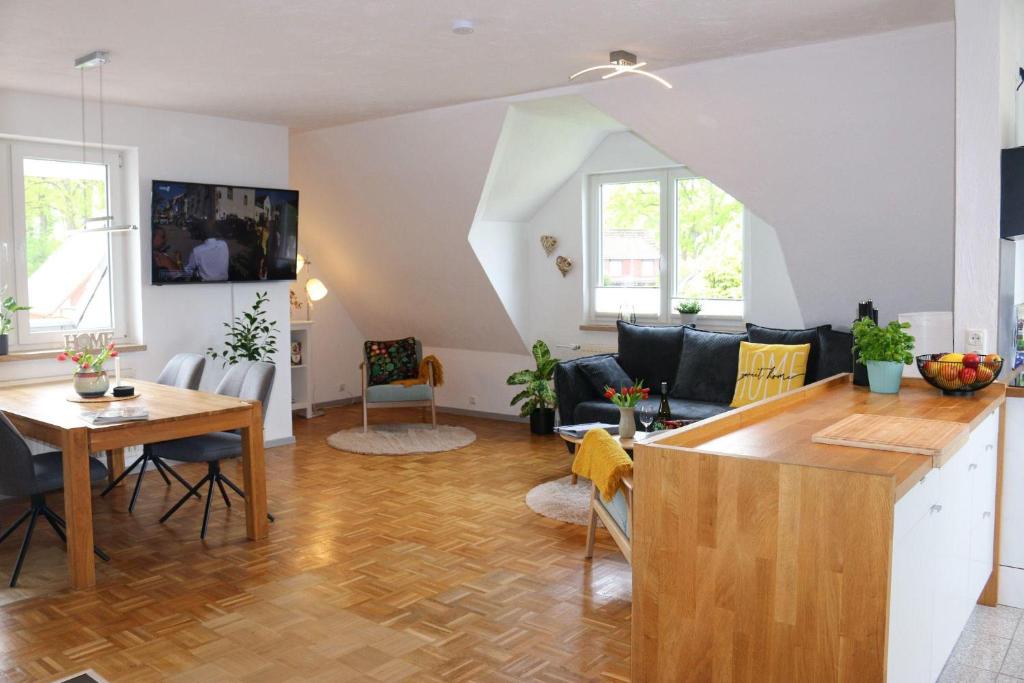 a living room with a kitchen and a dining room at Ferienwohnung-Familie-Baasch in Embsen