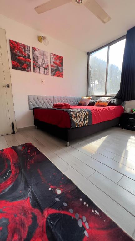 a bedroom with a bed and a large window at Edificio Genesis in Rodadero