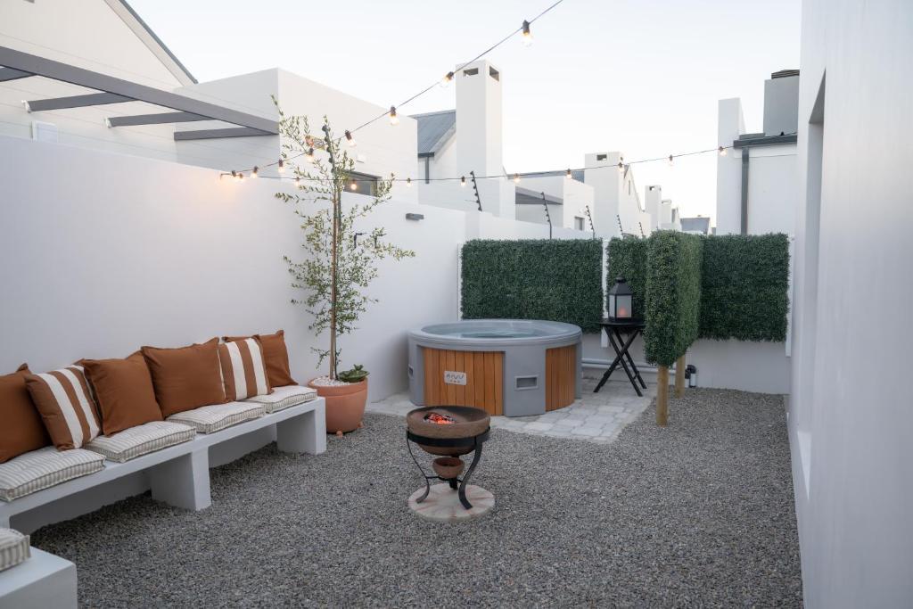 a living room with a couch and a table at Sout Huijs Langebaan with hot tub in Langebaan