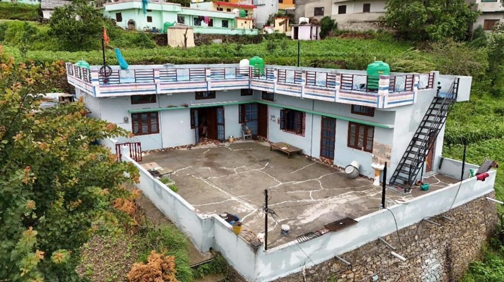 an aerial view of a house with a basketball court at Devki Homestay in Kanatal