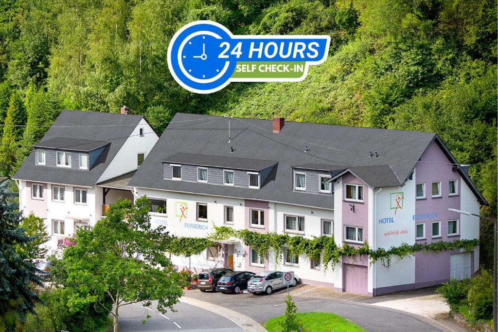 a house with a sign that says hours self check inn at Hotel Emmerich in Winningen
