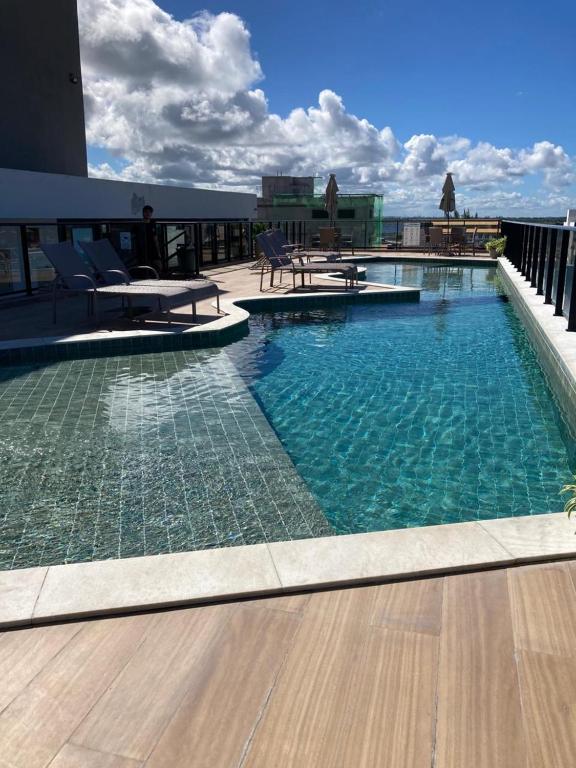 a large swimming pool on top of a building at Porto City - Flat 06 com Jacuzzi in Porto De Galinhas