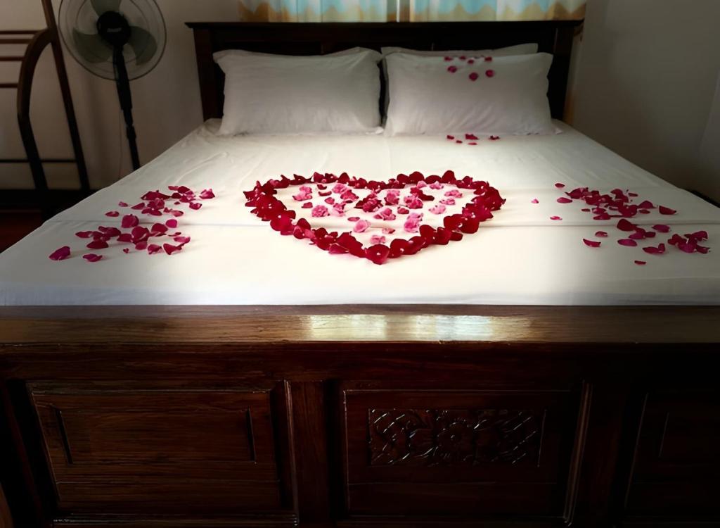 a heart made out of roses on a bed at Aqua Bliss Resort & Villa Bentota in Bentota