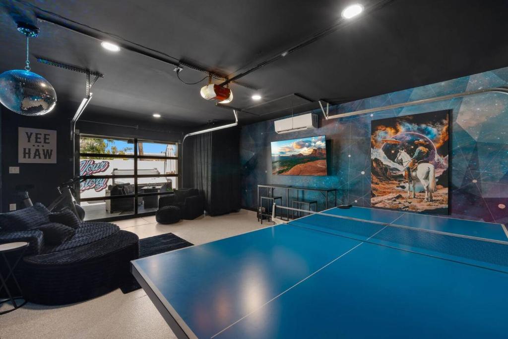 a living room with a blue ping pong table at Page House in Gilbert