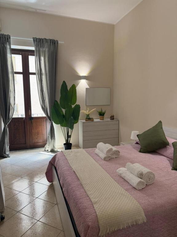 a bedroom with a large bed with two towels on it at Guest House Via Poerio in Catanzaro