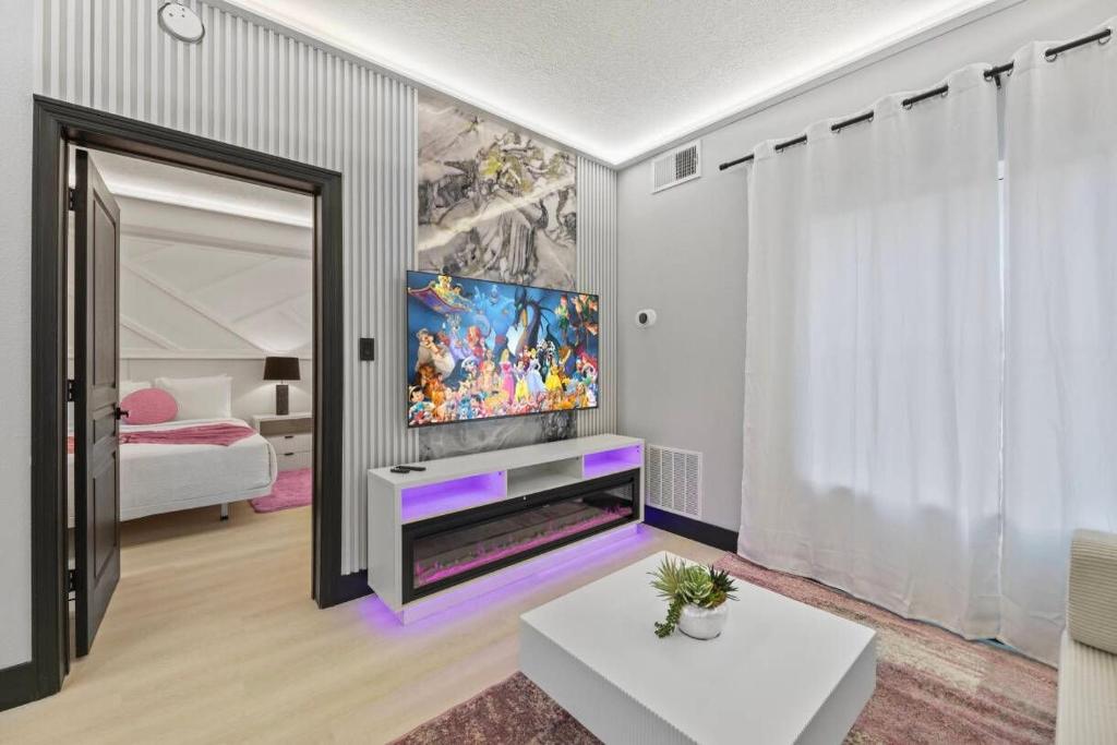 a living room with a tv and a large mirror at Hawthorn Suites Suite Near Universal & I-Drive in Orlando