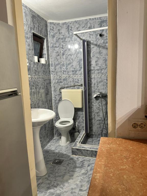 a bathroom with a toilet and a sink at Apartmani Bjelila in Tivat