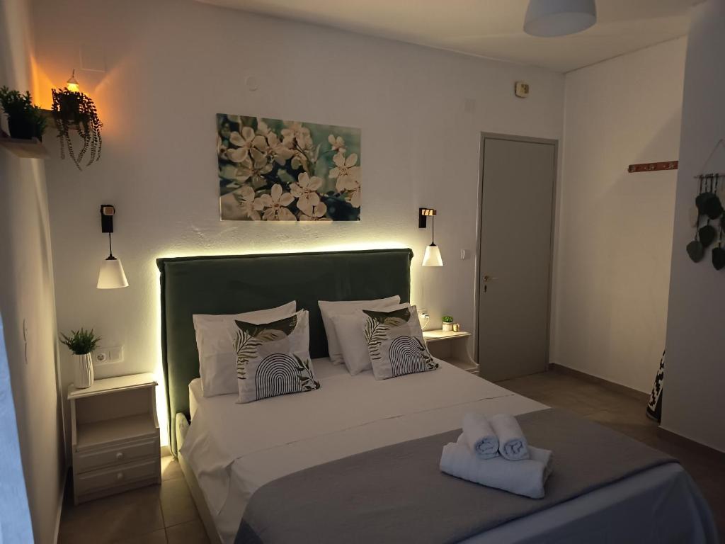 a bedroom with a bed with two towels on it at Iason studio 4 in Patitiri
