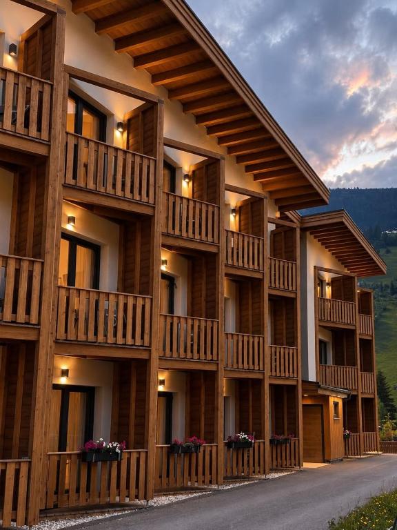 a building with balconies on the side of it at Rössl Lodge in Gerlos
