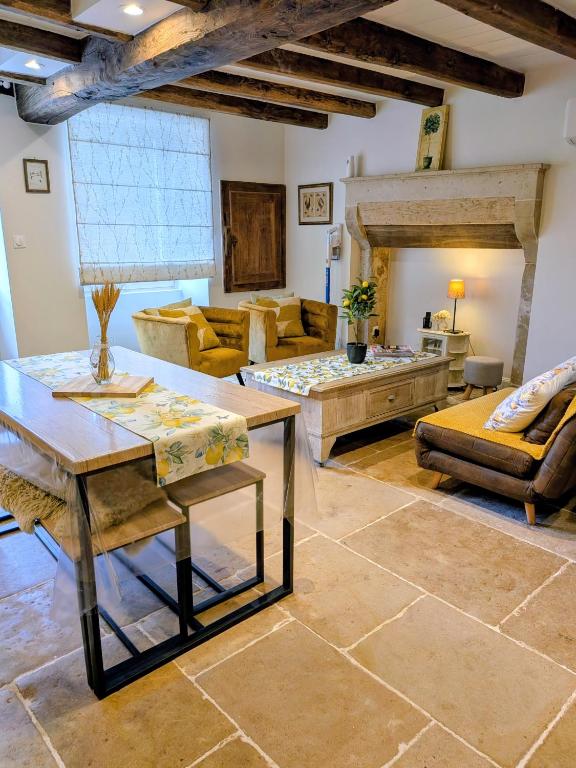 a living room filled with furniture and a table at Gîtes climatisés classés 4 étoiles Au Petit Bonheur de Lorigné in Lorigné