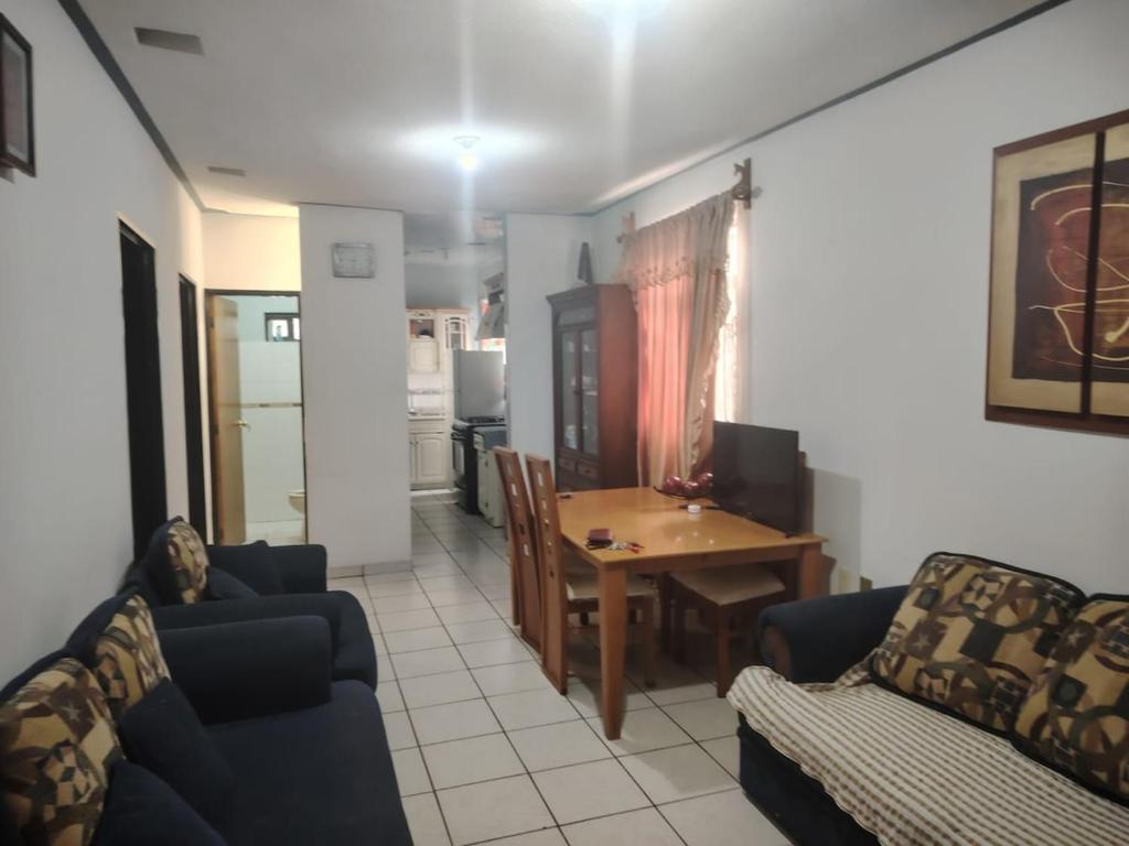 a living room with a couch and a dining room table at Comfortable and equipped house in Rioverde in Río Verde
