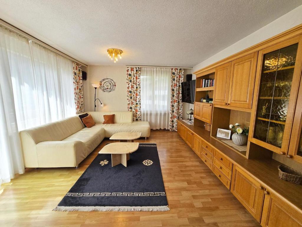 a living room with a couch and a table at Apartment Birkenstrasse 52 by Interhome in Engelberg