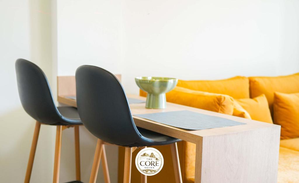 a table with two chairs and a couch at The Core Lezhe in Lezhë