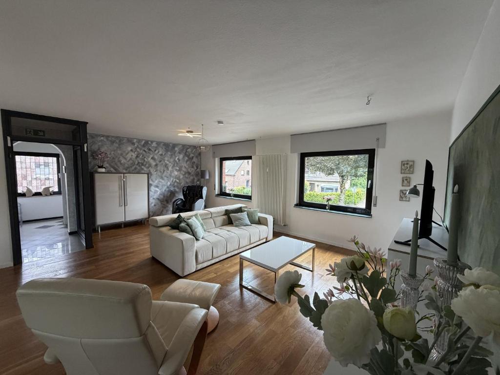 a living room with a couch and a table at Niederrhein Suite Kerken in Kerken