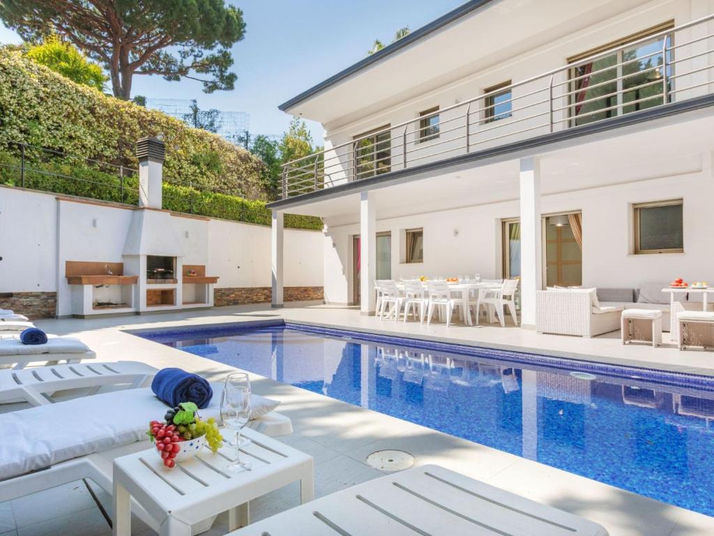 a villa with a swimming pool and a house at Villa Palmbeach by Interhome in Lloret de Mar