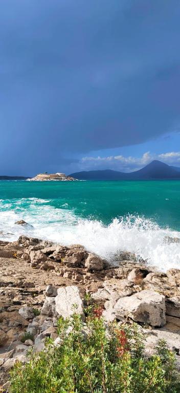 a body of water with waves crashing on the rocks at Villa Yulia in Luštica