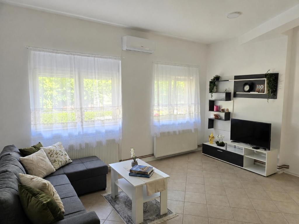 a living room with a couch and a table at Iskra Apartment 2 in Kragujevac