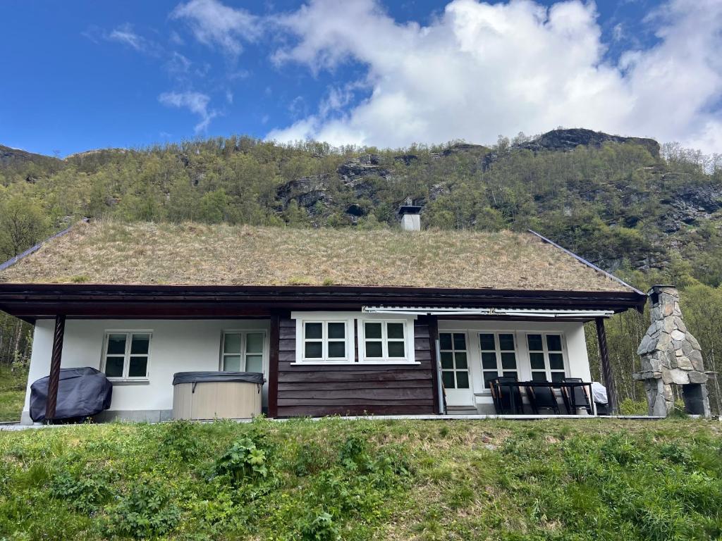 a small white house with a grass roof at Aurlandsdalen in Aurland