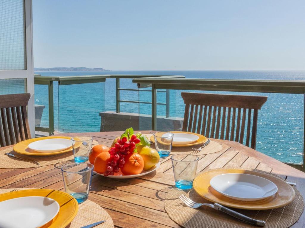 a wooden table with a plate of fruit on it at Apartment Vermell-8 by Interhome in Platja d'Aro