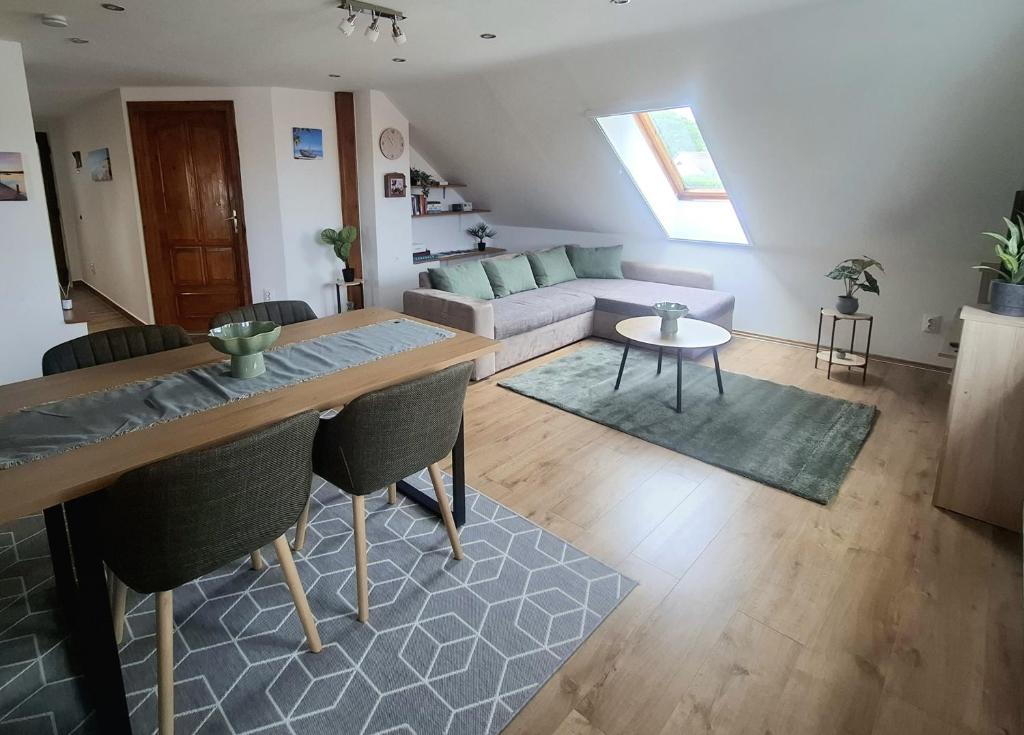 a living room with a couch and a table at Green Home Apartman in Nemesvámos