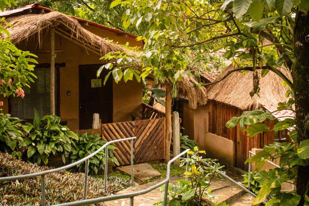 a small house with a thatch roof at Ixak Cabañas in La Pimienta