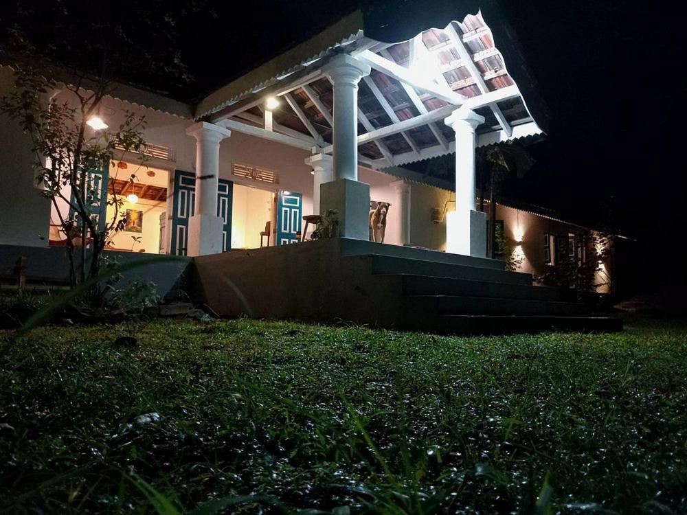a house with a lit up front at night at Nixon Anroos in Kavudupelella