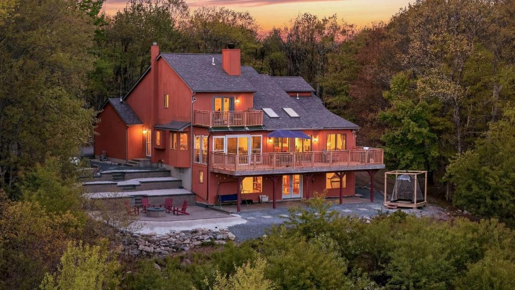 an aerial view of a large red house at Stone Ridge by AvantStay in Albrightsville