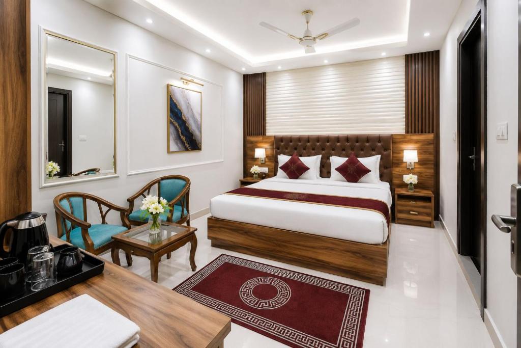a hotel room with a bed and a desk at Hotel ONBellamount Comfort Villa Delhi Airport - Free Airport PickUp & Drop in New Delhi
