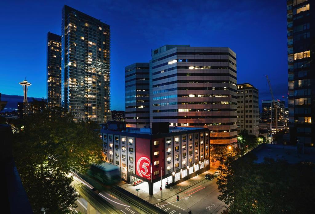 a city skyline with tall buildings at night at Staypineapple, Hotel FIVE, Downtown Seattle in Seattle