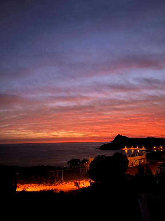 a sunset with a view of the ocean at Dar halouma in Tabarka