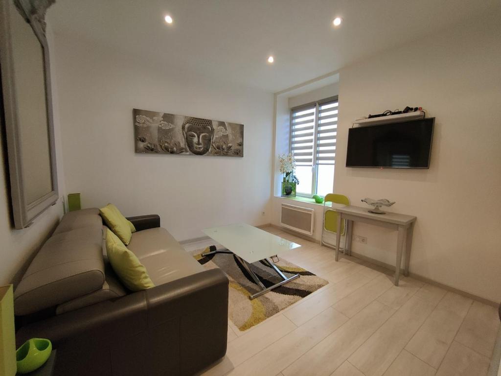 a living room with a couch and a flat screen tv at Ancre Zen in Les Sables-d'Olonne