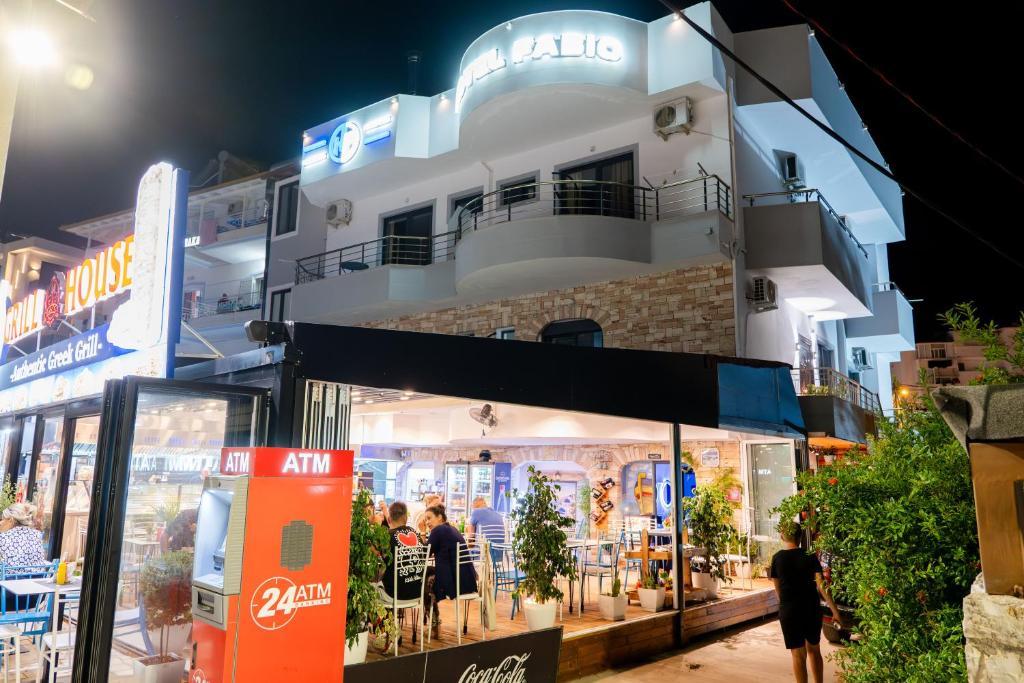 a store front of a building at night at Hotel Fabio in Ksamil