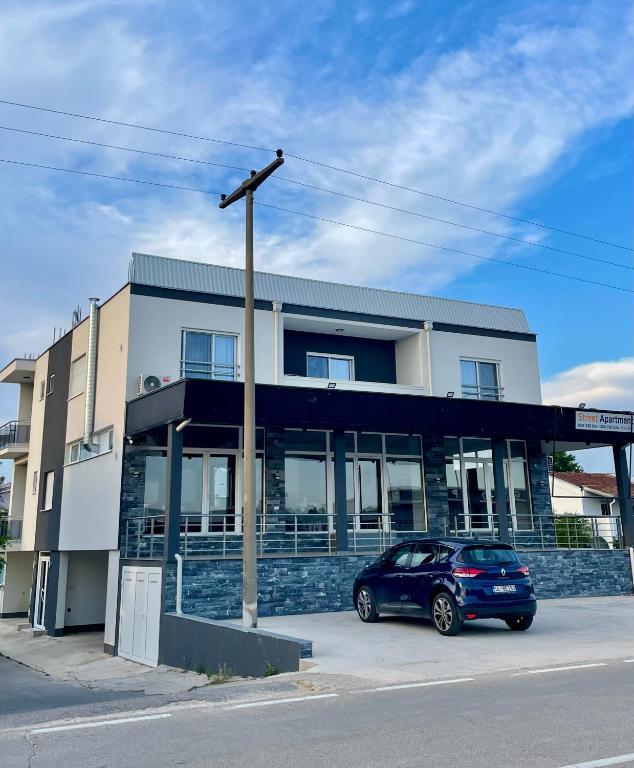 a blue car parked in front of a building at Street Apartments in Ulcinj